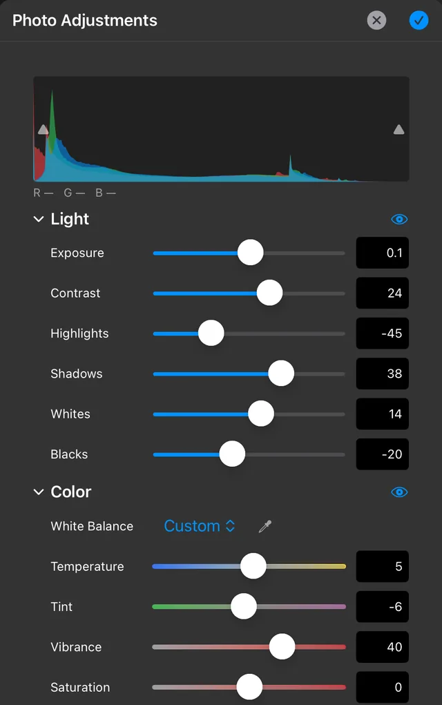 The Photo Adjustments panel showing a histogram and Light and Color controls with the values used for the lake edit.